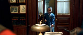 Movie still from “The Secret in Their Eyes” (2009), directed by Juan José Campanella – A man standing in front of a mirror in a room; Medium shot, Low angle