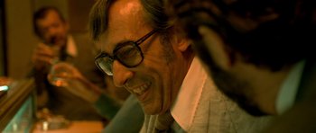 Movie still from “The Secret in Their Eyes” (2009), directed by Juan José Campanella – A person wearing glasses; Close Up shot, Low angle