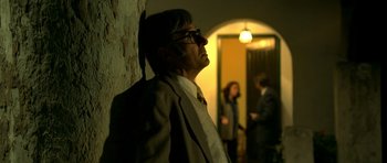 Movie still from “The Secret in Their Eyes” (2009), directed by Juan José Campanella – An older man wearing a suit and tie; Medium shot, Low angle