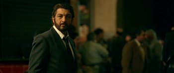 Movie still from “The Secret in Their Eyes” (2009), directed by Juan José Campanella – A person wearing a suit and tie; Close Up shot, Low angle