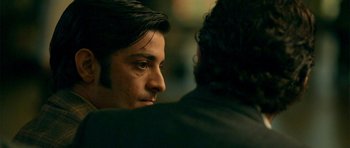 Movie still from “The Secret in Their Eyes” (2009), directed by Juan José Campanella – A person sitting down with another person; Close Up shot, Over the shoulder angle