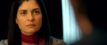 Movie still from “The Secret in Their Eyes” (2009), directed by Juan José Campanella – A person with long black hair; Close Up shot, Over the shoulder angle