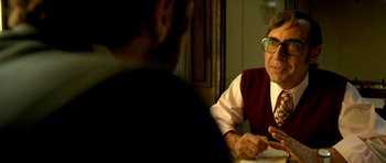 Movie still from “The Secret in Their Eyes” (2009), directed by Juan José Campanella – An older man sitting in front of a younger man; Close Up shot, Over the shoulder angle