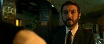 Movie still from “The Secret in Their Eyes” (2009), directed by Juan José Campanella – A person wearing a suit and tie; Close Up shot, Over the shoulder angle