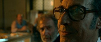 Movie still from “The Secret in Their Eyes” (2009), directed by Juan José Campanella – A man with glasses and a beard is looking at the camera; Close Up shot, Over the shoulder angle