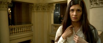 Movie still from “The Secret in Their Eyes” (2009), directed by Juan José Campanella – A woman with long hair standing in front of a building; Close Up shot, Low angle