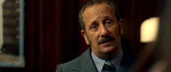 Movie still from “The Secret in Their Eyes” (2009), directed by Juan José Campanella – A person wearing a suit and tie; Close Up shot, Low angle