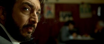 Movie still from “The Secret in Their Eyes” (2009), directed by Juan José Campanella – A person smoking a cigarette; Close Up shot, Over the shoulder angle
