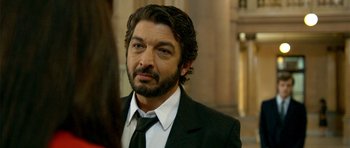 Movie still from “The Secret in Their Eyes” (2009), directed by Juan José Campanella – A person wearing a suit and tie; Close Up shot, Over the shoulder angle