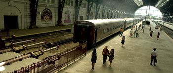 Movie still from “The Secret in Their Eyes” (2009), directed by Juan José Campanella – People walking in a train station next to a train; Extreme Wide shot, High angle