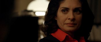 Movie still from “The Secret in Their Eyes” (2009), directed by Juan José Campanella – A person wearing a red and black shirt; Close Up shot, Over the shoulder angle