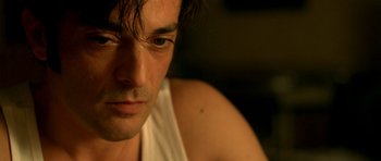 Movie still from “The Secret in Their Eyes” (2009), directed by Juan José Campanella – A man's face in a white shirt; Close Up shot, Low angle