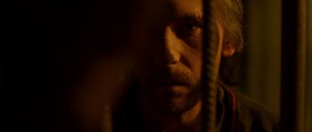 Movie still from “The Secret in Their Eyes” (2009), directed by Juan José Campanella – A person with a beard; Extreme Close Up shot, Over the shoulder angle