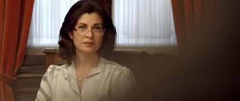 Movie still from “The Secret in Their Eyes” (2009), directed by Juan José Campanella – A person wearing glasses near a window; Close Up shot, Over the shoulder angle