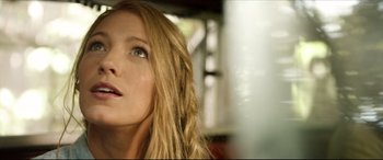 Movie still from “The Shallows” (2016), directed by Jaume Collet-Serra – A person with long blonde hair; Close Up shot, Low angle