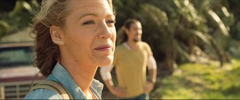Movie still from “The Shallows” (2016), directed by Jaume Collet-Serra – A woman and a man standing next to each other in a forest; Close Up shot, Over the shoulder angle