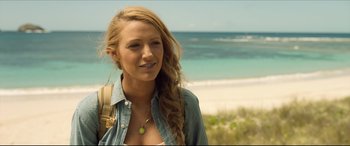Movie still from “The Shallows” (2016), directed by Jaume Collet-Serra – A beautiful young woman standing on top of a sandy beach; Close Up shot, Over the shoulder angle