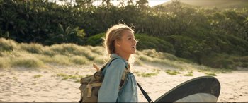 Movie still from “The Shallows” (2016), directed by Jaume Collet-Serra – A woman with a backpack walking on the beach; Medium shot, Low angle