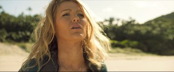 Movie still from “The Shallows” (2016), directed by Jaume Collet-Serra – A beautiful blonde woman with long hair looking upward; Close Up shot, Low angle
