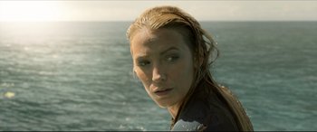 Movie still from “The Shallows” (2016), directed by Jaume Collet-Serra – A person near a body of water; Close Up shot, Over the shoulder angle
