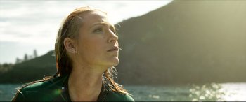 Movie still from “The Shallows” (2016), directed by Jaume Collet-Serra – A beautiful young woman with long red hair wearing a green shirt; Close Up shot, Low angle
