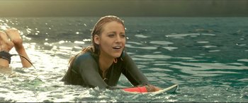 Movie still from “The Shallows” (2016), directed by Jaume Collet-Serra – A woman in the water with a surfboard; Medium shot, Over the shoulder angle