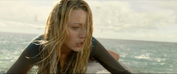 Movie still from “The Shallows” (2016), directed by Jaume Collet-Serra – A person on a surfboard in the water; Close Up shot, Low angle