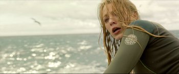 Movie still from “The Shallows” (2016), directed by Jaume Collet-Serra – A woman with wet hair standing in front of the ocean; Close Up shot, Over the shoulder angle