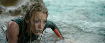 Movie still from “The Shallows” (2016), directed by Jaume Collet-Serra – A woman in a wetsuit in the water; Close Up shot, High angle