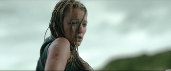 Movie still from “The Shallows” (2016), directed by Jaume Collet-Serra – A woman with wet hair and a green shirt; Close Up shot, Low angle