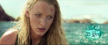Movie still from “The Shallows” (2016), directed by Jaume Collet-Serra – A person with long blonde hair; Close Up shot, Over the shoulder angle