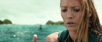 Movie still from “The Shallows” (2016), directed by Jaume Collet-Serra – A person near a body of water; Close Up shot, Over the shoulder angle