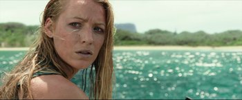 Movie still from “The Shallows” (2016), directed by Jaume Collet-Serra – A person in the water near a body of water; Close Up shot, High angle