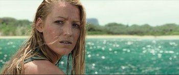 Movie still from “The Shallows” (2016), directed by Jaume Collet-Serra – A person with long hair on a body of water; Close Up shot, Low angle