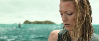 Movie still from “The Shallows” (2016), directed by Jaume Collet-Serra – A person in the water near a body of water; Close Up shot, High angle
