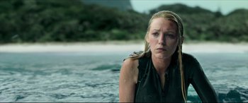 Movie still from “The Shallows” (2016), directed by Jaume Collet-Serra – A woman standing in the water near the shore; Close Up shot, Over the shoulder angle