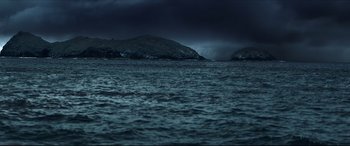 Movie still from “The Shallows” (2016), directed by Jaume Collet-Serra – A body of water near a body of water under a cloudy sky; Extreme Wide shot, High angle