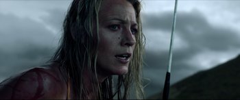 Movie still from “The Shallows” (2016), directed by Jaume Collet-Serra – A person holding a gun; Close Up shot, Low angle