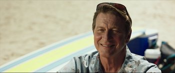 Movie still from “The Shallows” (2016), directed by Jaume Collet-Serra – A person wearing a shirt and sunglasses; Close Up shot, Low angle