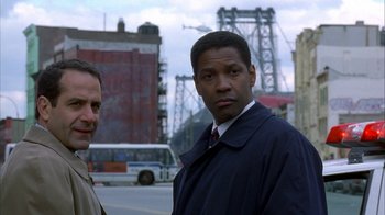Movie still from “The Siege” (1998), directed by Edward Zwick – Two men standing on the side of the street; Close Up shot, Low angle