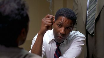 Movie still from “The Siege” (1998), directed by Edward Zwick – A man in a white dress shirt and a red and blue striped neck tie; Close Up shot, Over the shoulder angle