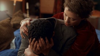 Movie still from “The Siege” (1998), directed by Edward Zwick – A woman holding a man's face while he is holding his hands over his face; Close Up shot, Over the shoulder angle