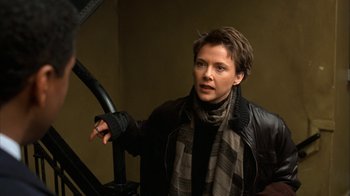 Movie still from “The Siege” (1998), directed by Edward Zwick – A woman in a leather jacket and a scarf; Close Up shot, Over the shoulder angle