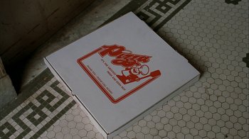 Movie still from “The Siege” (1998), directed by Edward Zwick – A pizza box sitting on top of a floor; Extreme Close Up shot, Overhead angle