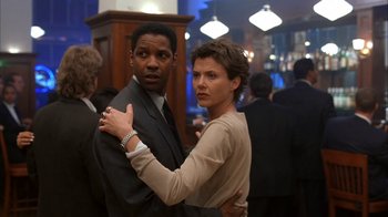 Movie still from “The Siege” (1998), directed by Edward Zwick – A man and a woman posing for a picture; Medium shot, Low angle