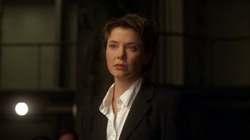 Movie still from “The Siege” (1998), directed by Edward Zwick – A woman wearing a suit and a white shirt; Close Up shot, Low angle