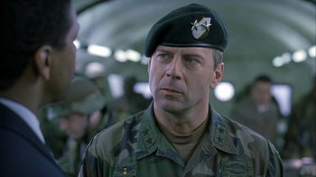 Movie still from “The Siege” (1998), directed by Edward Zwick – A man in a military uniform wearing a hat; Close Up shot, Low angle