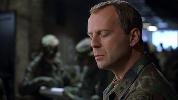 Movie still from “The Siege” (1998), directed by Edward Zwick – A man in military fatigues looking down at his face; Close Up shot, Low angle