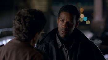 Movie still from “The Siege” (1998), directed by Edward Zwick – A man and a woman talking in the dark; Close Up shot, Over the shoulder angle