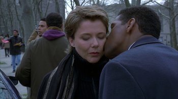 Movie still from “The Siege” (1998), directed by Edward Zwick – A woman and a man kissing each other in a crowd; Close Up shot, Over the shoulder angle